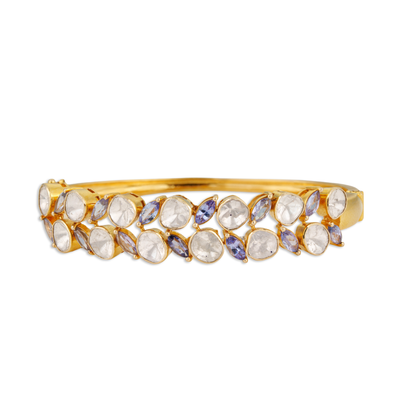 Gold bracelet with gemstones on a white background