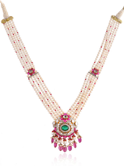 Delicate necklace with pearls, gemstones, and a central pendant on a white background