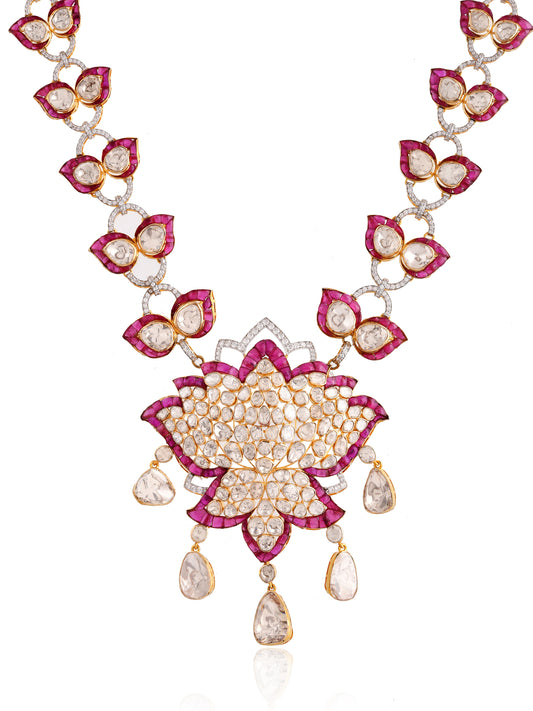 Ornate necklace with floral design and gemstones on a white background